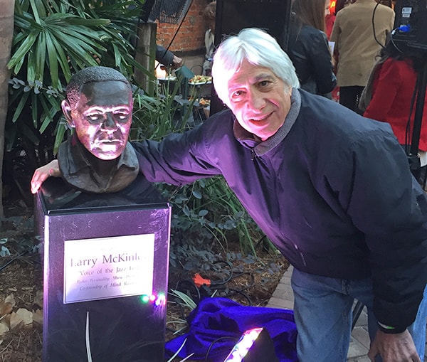 Eddie Sapir poses with Larry McKinley's bronze bust at the unveiling ceremony in Musical Legends Park, 2016